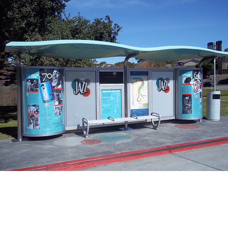 A bus shelter designed to highlight Jazz with a Jazz logo on the back panels, Jazz history on the two curved ends and a bench in the middle with a rider map displayed behind