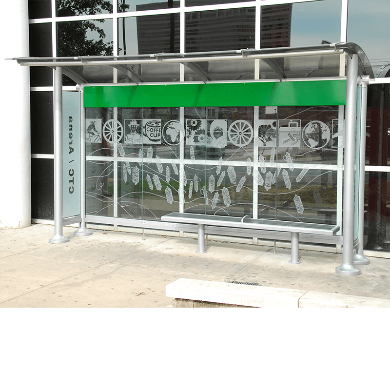 A bus shelter with a custom back wall design and bench seating.