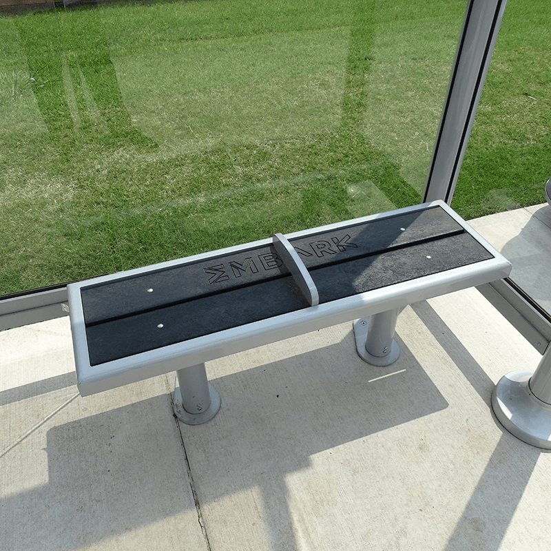 slatted bench seating under a bus shelter