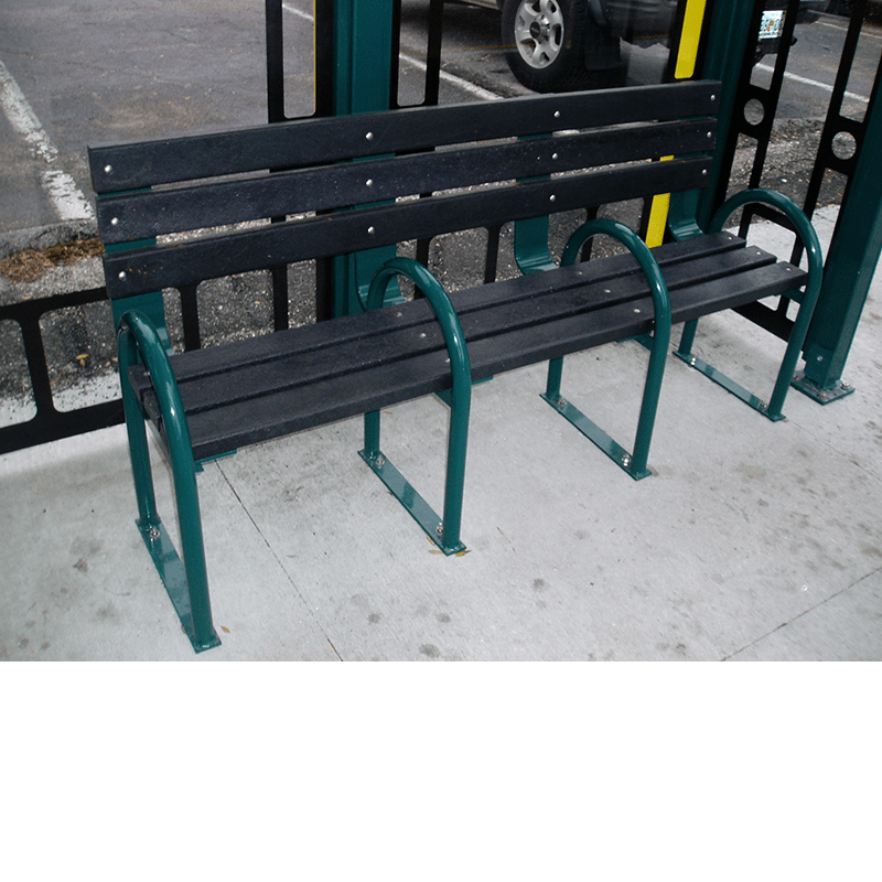 A bench inside a bus shelter with seating for three, separated by bars for each.