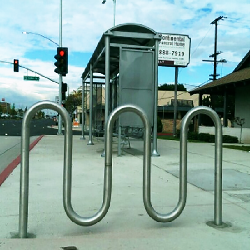 A bike parking rack is seen outside a bus shelter.