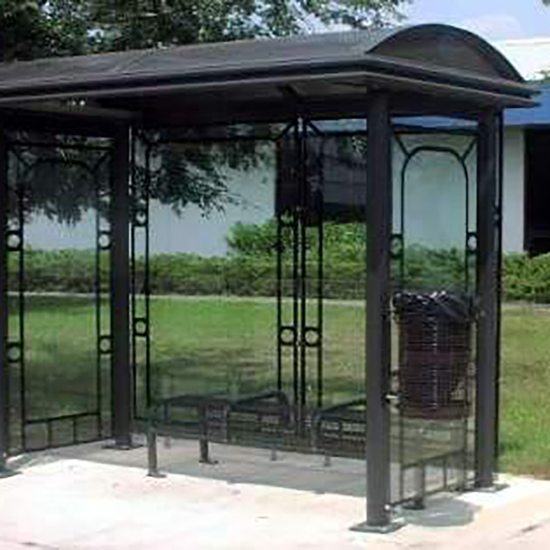 A sierrna bus shelter with bench seating, an attached trash receptacle on the right outside and a design around each panel.