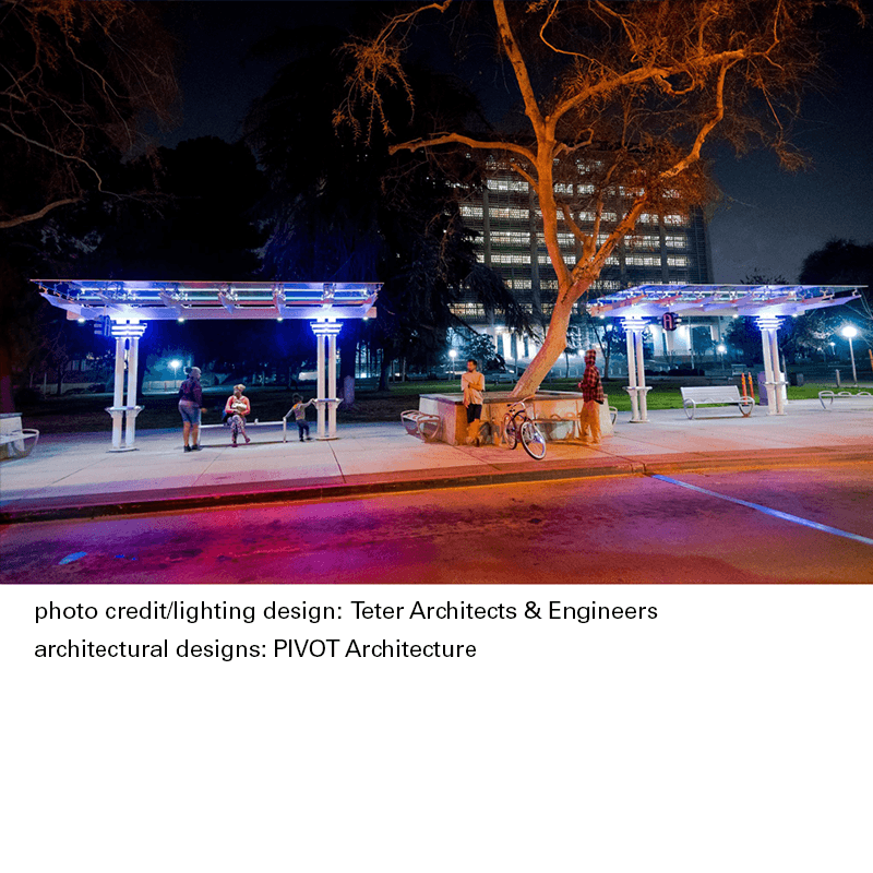 Bus shelter seen at night with riders awaiting the next bus at this transit station with a caption below the photo giving photo and architectural credit.