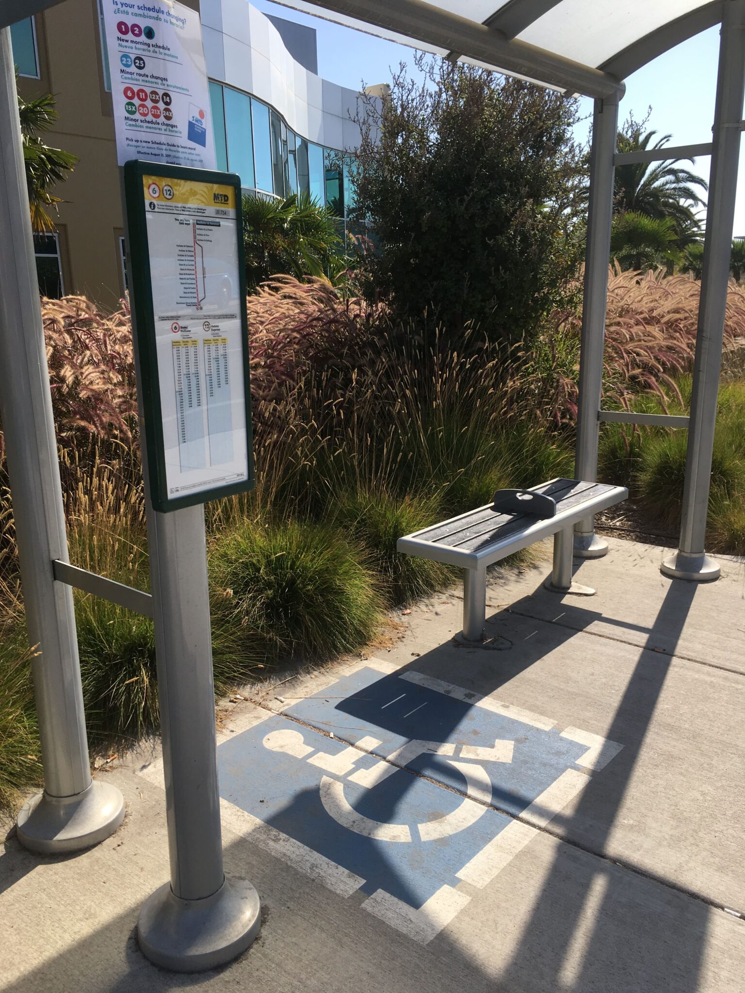 Close up view of the painted handicap section of the bus shelter next to the bus information display