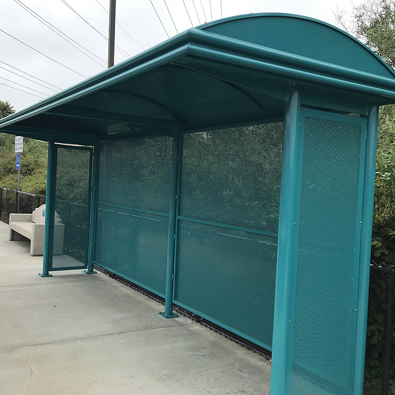 A Sierrna bus shelter with a bench on the outside left.