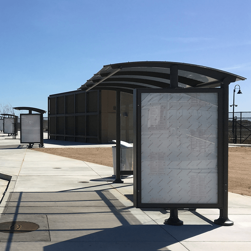 Multiple siga sunset bus shelters are seen from the right side with empty advertising displays on their right panels.