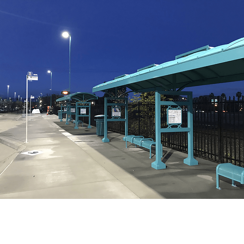 A signa custom bus shelter seen next to multiple others at a transportation hub.