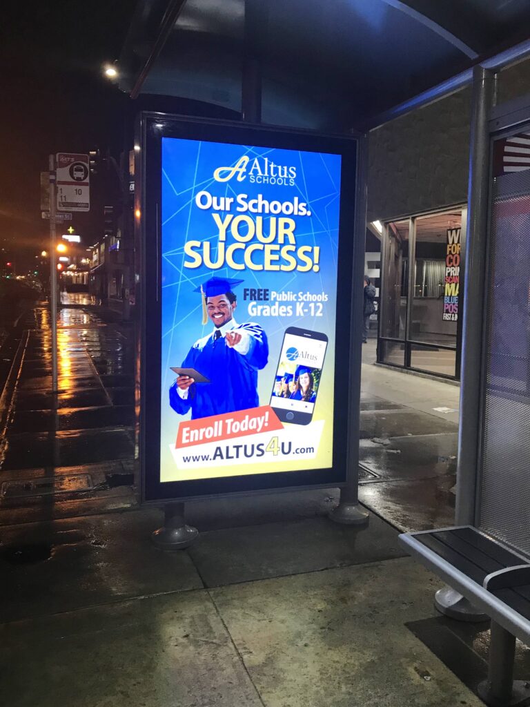 Evening lit advertising display on bus shelter