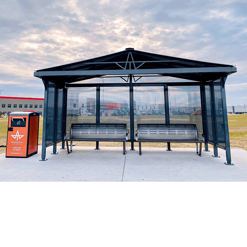 A bus shelter with two benches under the shelter and a trash receptacle on the outside left.