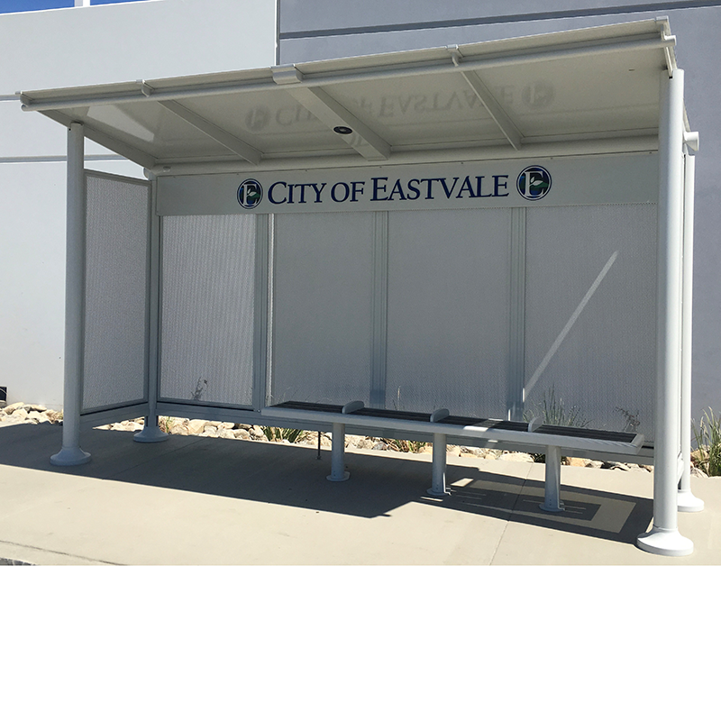 A signa empire bus shelter with bench seating and a City of Eastvale sign on the top of the back panels.