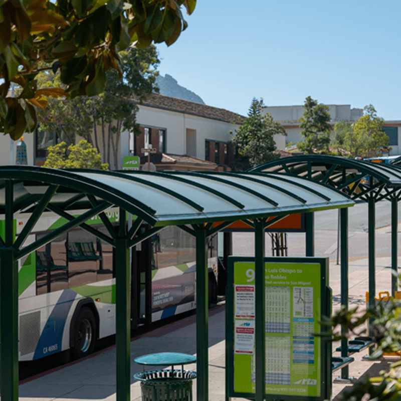 An overhead view of two bus shelters with a bus pulled up alongside the curb for riders to enter.