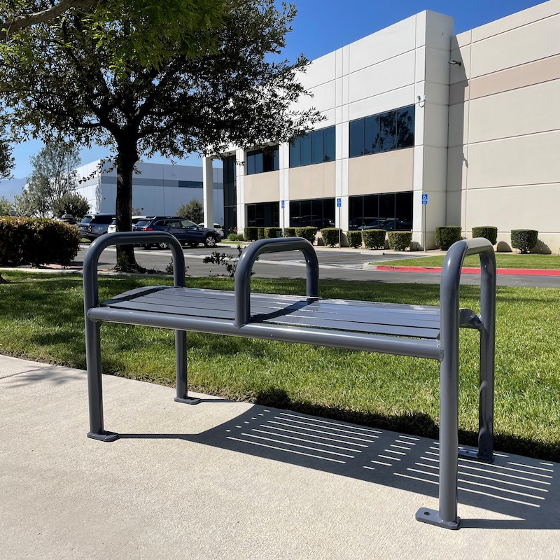 A two seat bench with handles on each and and in the middle.