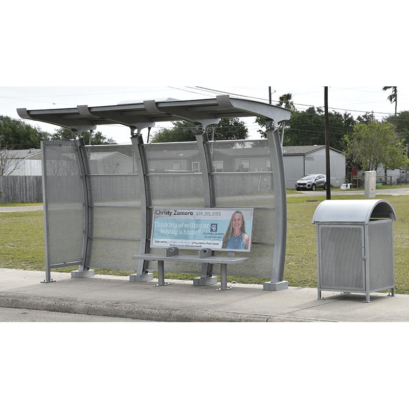 front view of a signa crescent bus shelter with a trash receptacle on the right and a bench advertisement on the bench inside the shelter