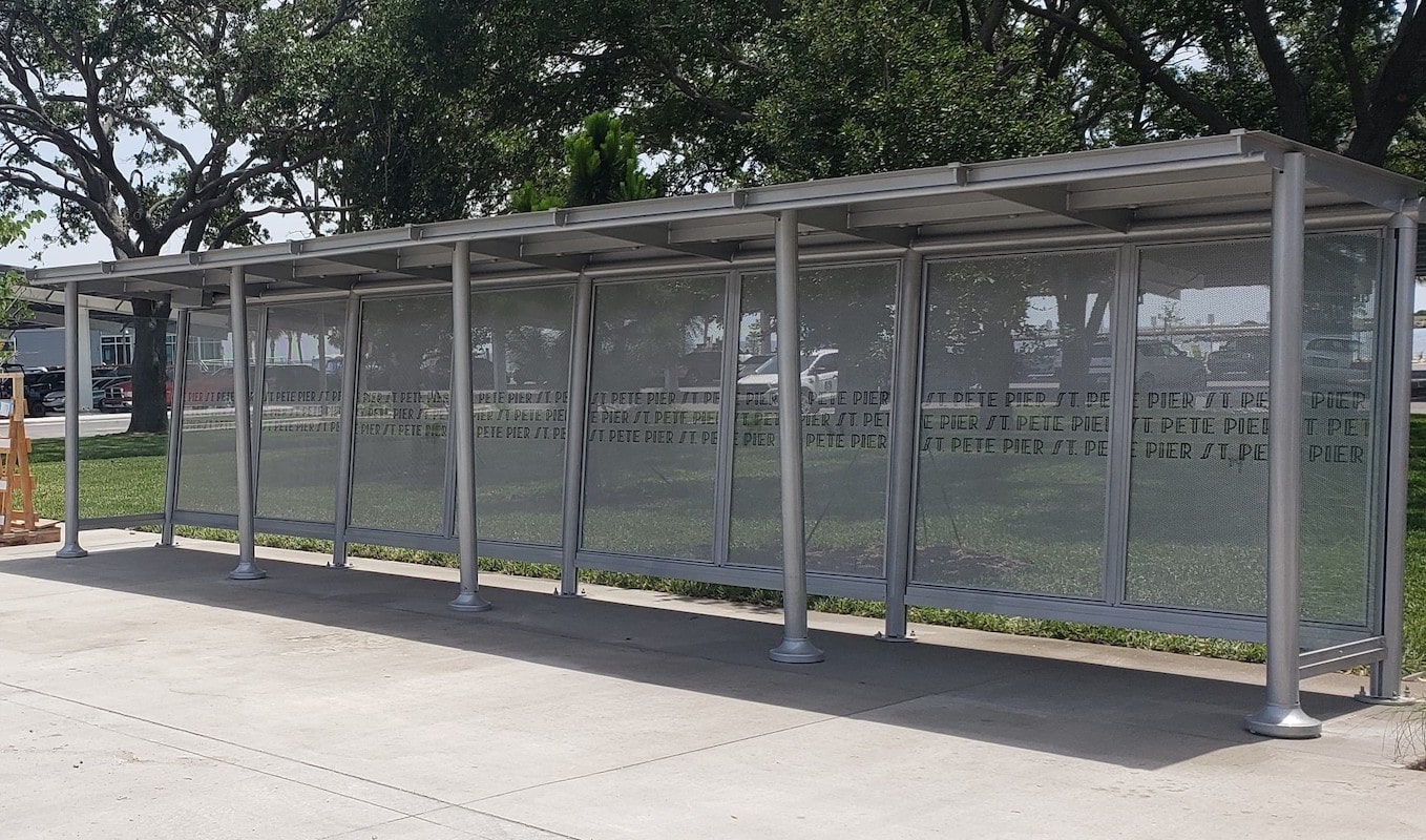 A Sunset Empire bus shelter with custom back panels with the stop's name.