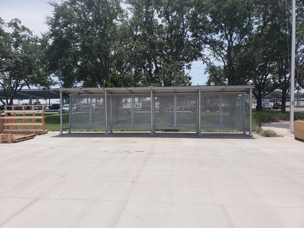 A Sunset Empire bus shelter seen from the front with construction pallets next to it as it is being completed for riders.