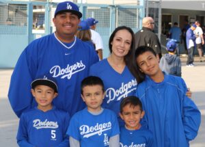 A family of 6 in Dodgers gear with four boys and their two parents.