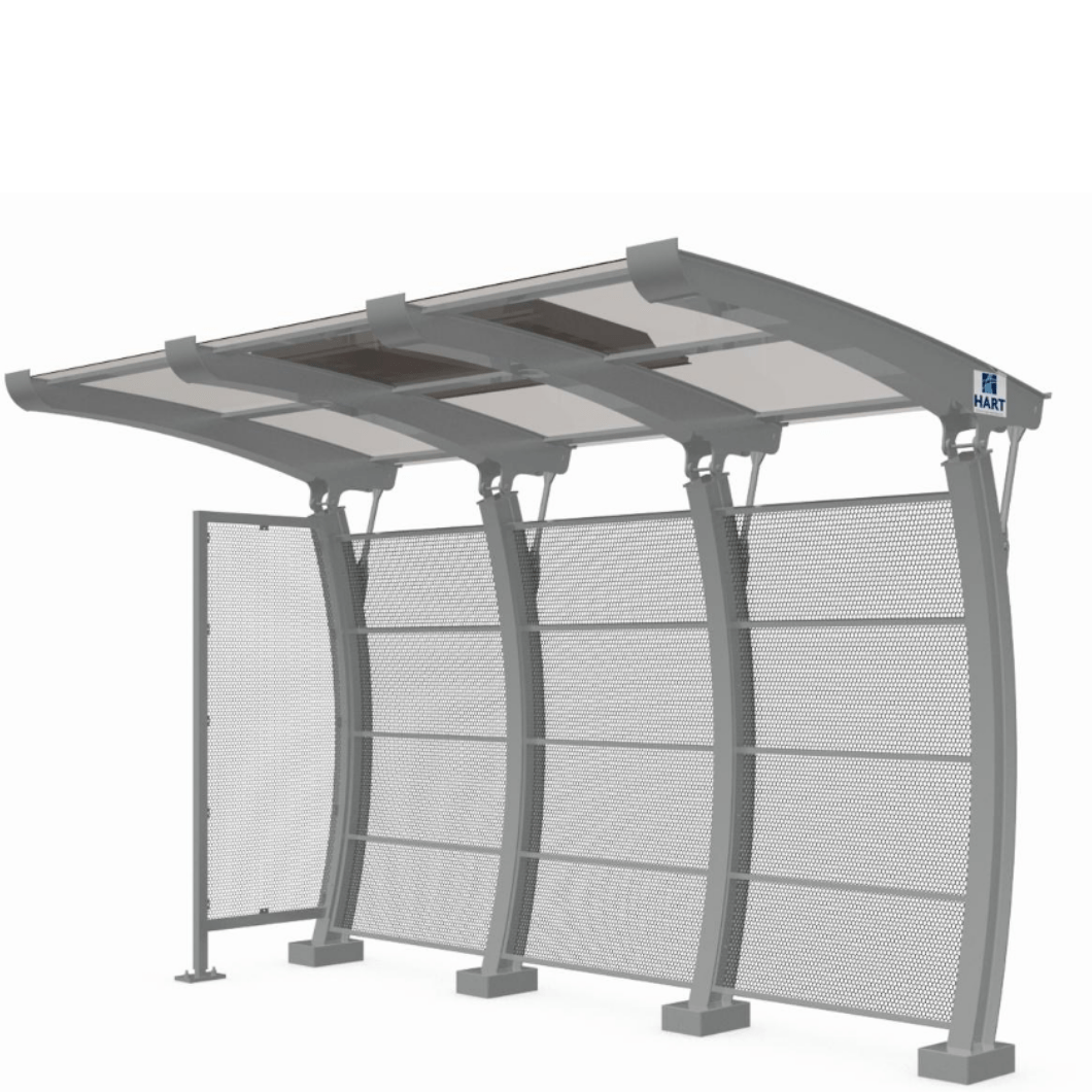 A bus shelter is seen by itself with an arched back design and rounded roof to match.