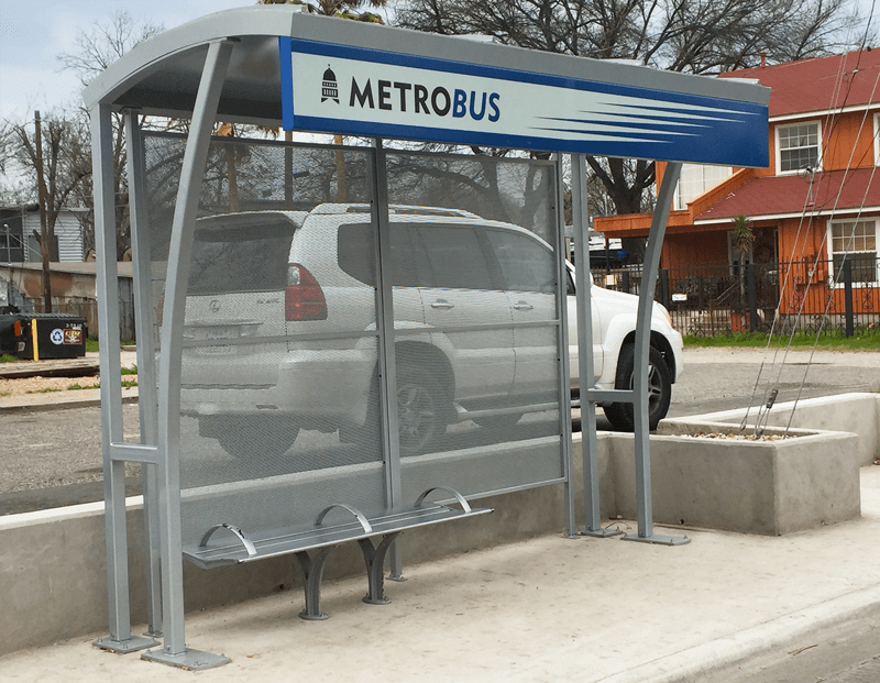 A metro bus shelter with bench seating for three from the right side view