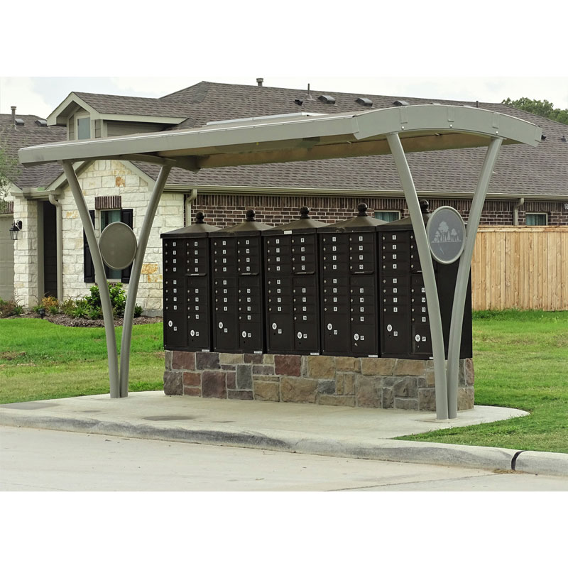 A shelter is seen covering community mailboxes with an arched roof for full weather protection.