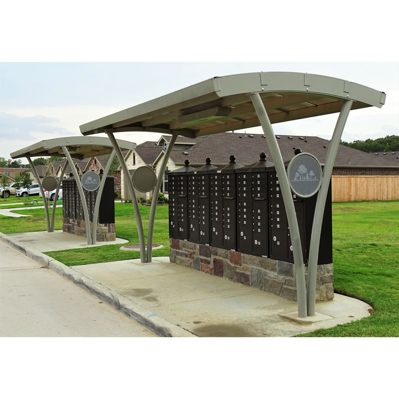 Two arched shelters are seen side by side covering a community's mail boxes from the weather and sun.