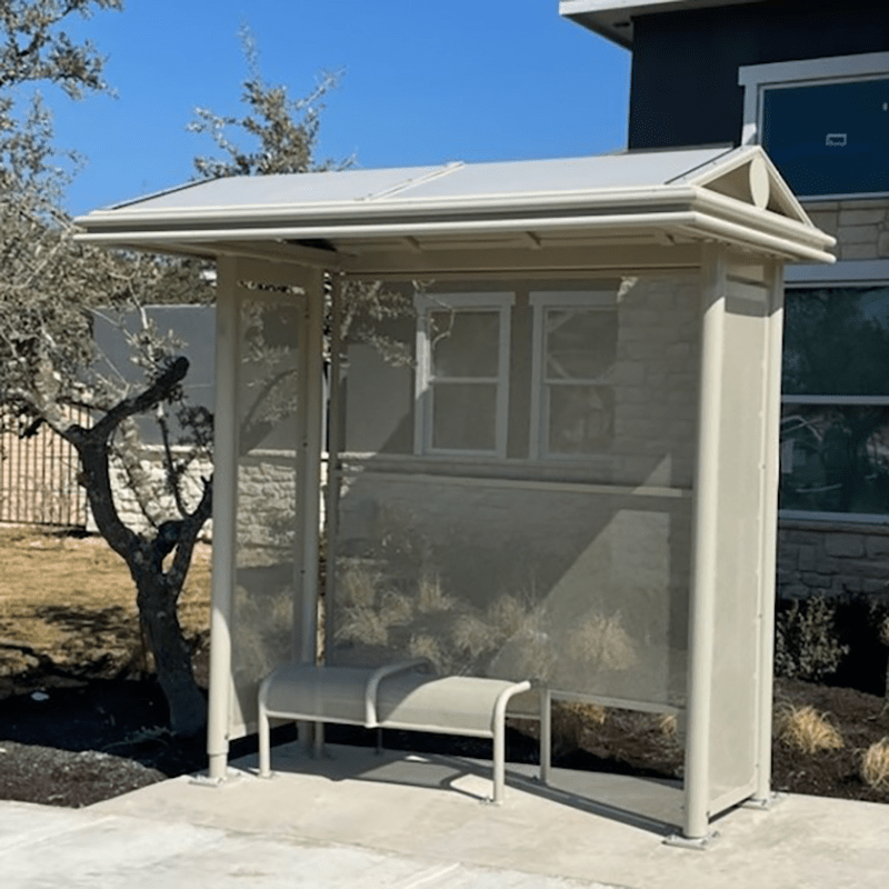 A bus shelter is seen from the front right with bench seating for two.
