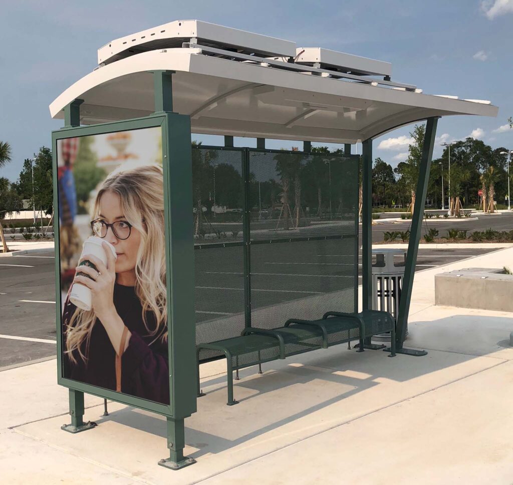 advertisement seen on the right side of a green siga custom bus shelter with bench seating