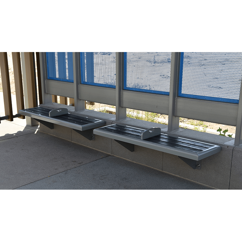side view of street furniture seating attached to the concrete base of the bus shelter