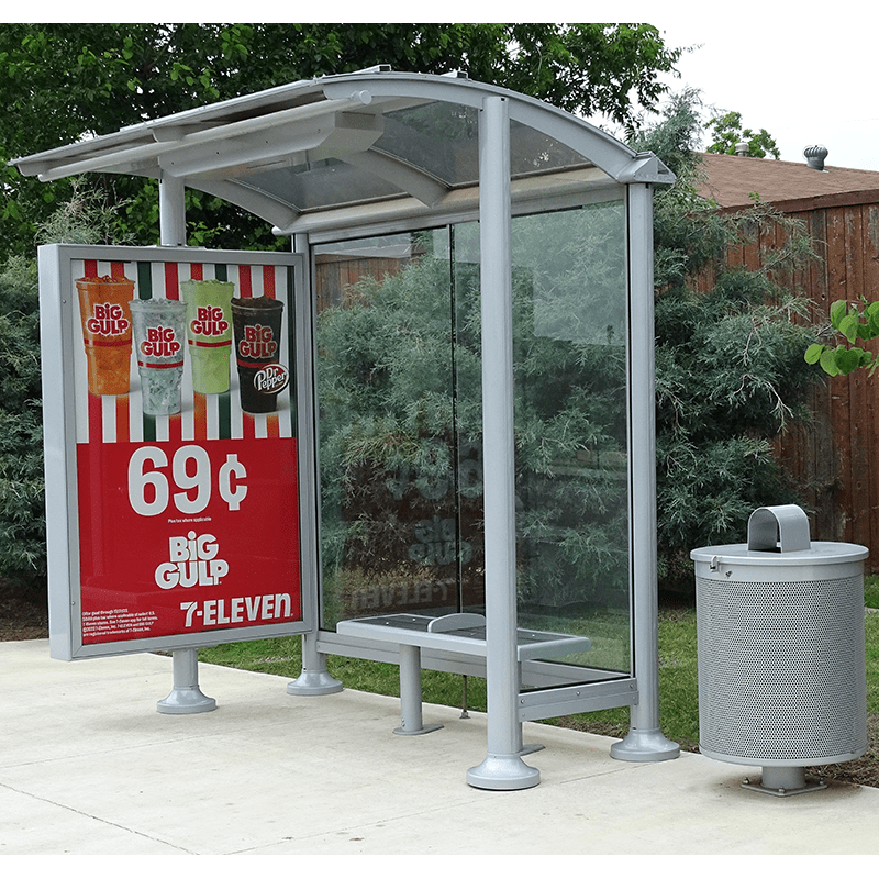 Right facing bus siga orion bus shelter includes a double sided advertising display and trash receptacle.