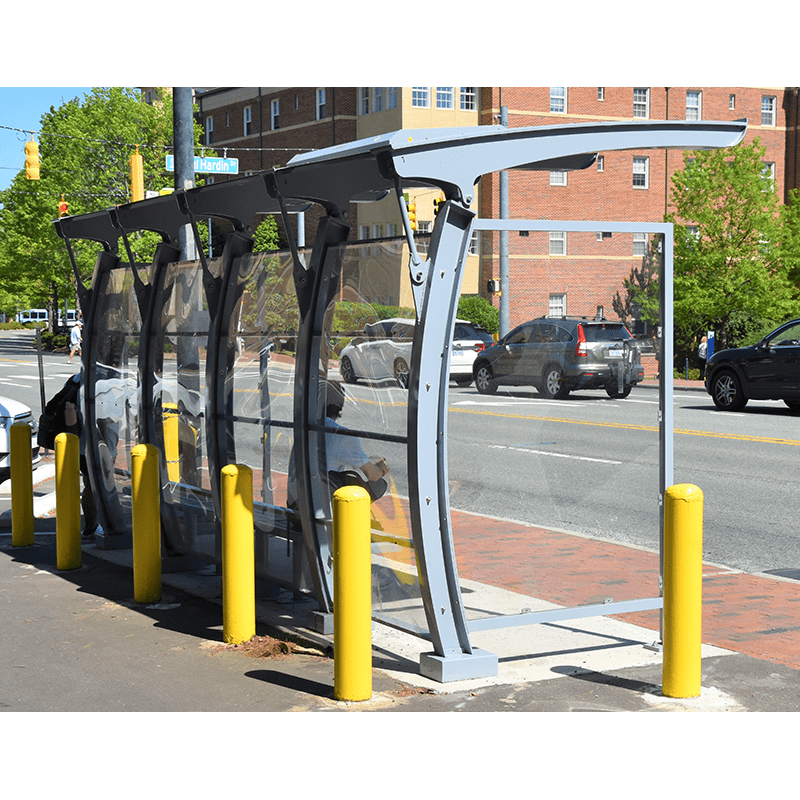 Back view of the Signa Crescent bus shelter in a light blue with bench seating for passengers as they wait at this city bus stop