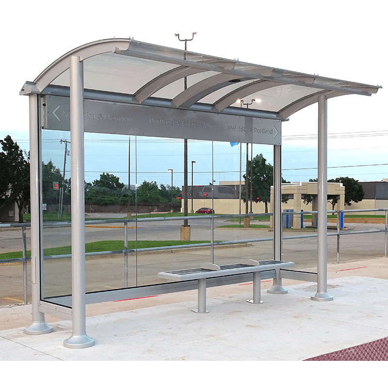 right front side view of a signa orion bus shelter with metal engraved bus stop name and bench seating