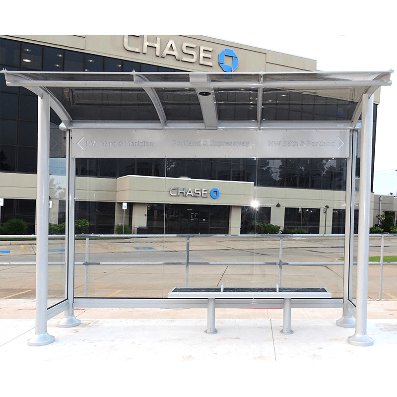 front view of the signa orion bus shelter with a single bench and glass siding.