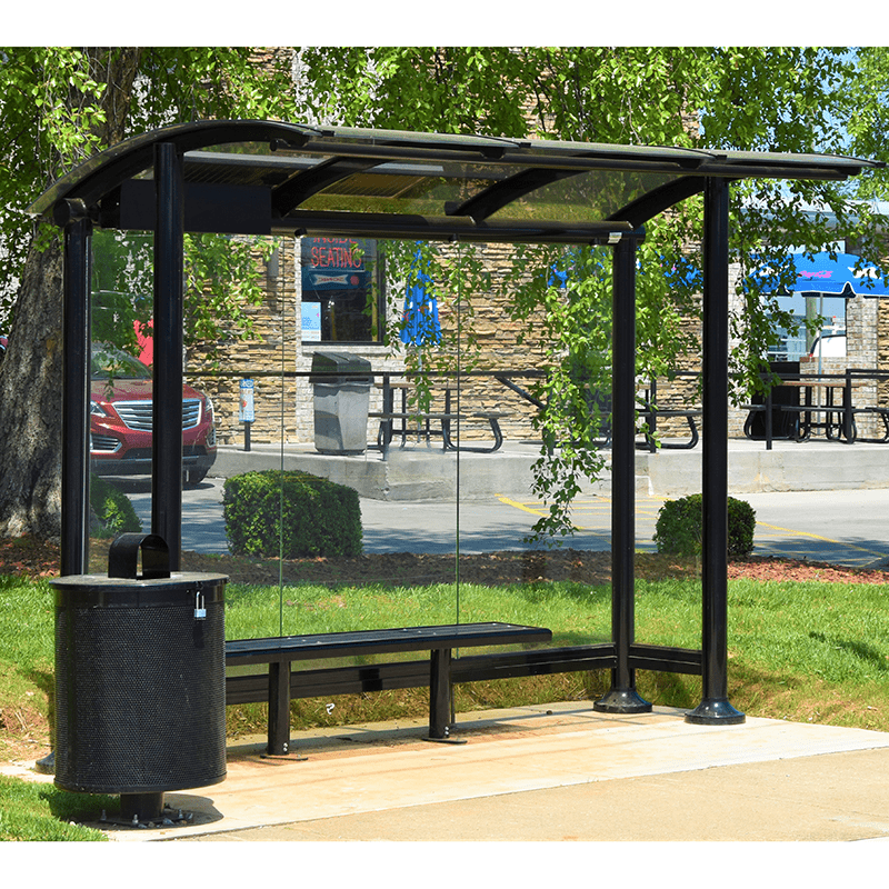 Right side view of a signa sunset bus shelter including bench seating and a trash receptacle