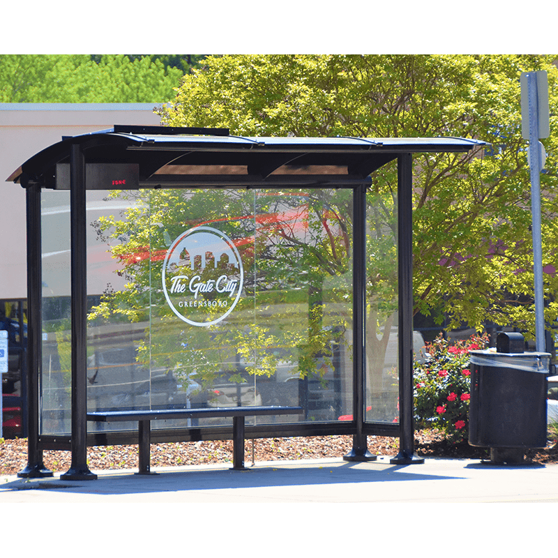 Signa Sunset bus shelter with a custom city emblem decal on the glass siding