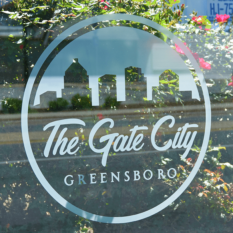 Custom decal for the city of Greensboro on a signa sunset bus shelter glass
