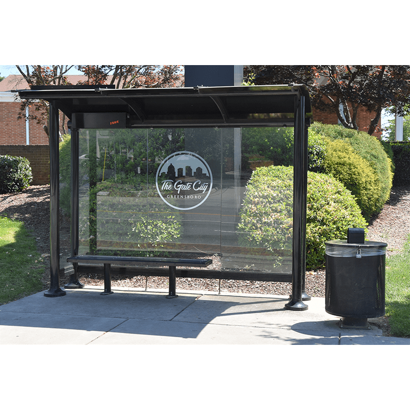 A Signa Sunset bus shelter for the city of Greensboro with a glass siding showcasing the city's logo