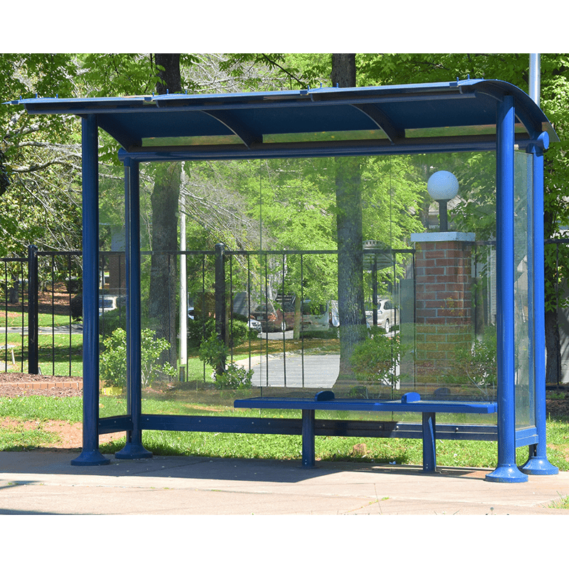 Signa Sunset bus shelter with a bench for three in a blue color positioned in a green neighborhood
