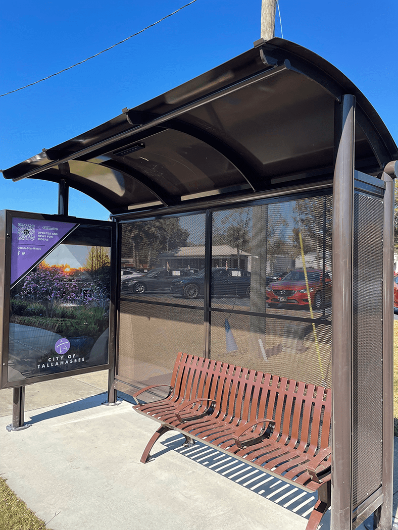 Brown bus shelter with advertising display and bench seating for three