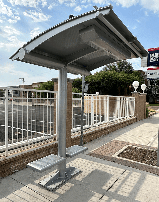 An ecoshade is seen from the left side with seats attached to either side of the ecoshade post.
