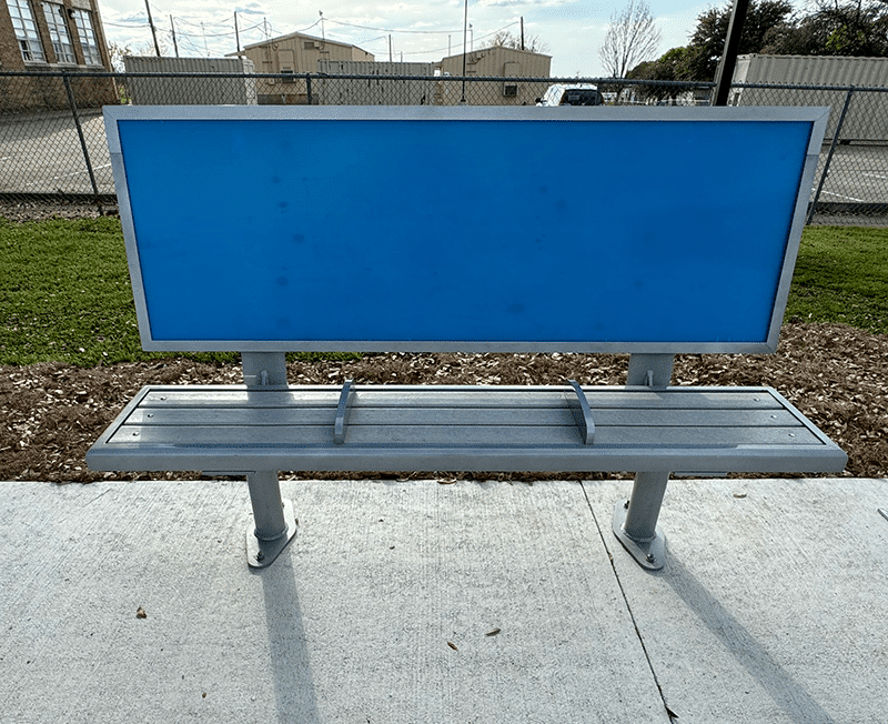 A head on view of a bench with an empty advertising back rest