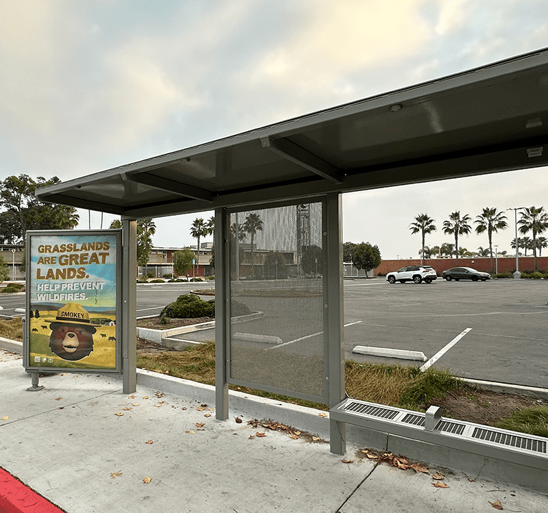 Siga Custom bus shelter with an advertising display on the right followed by covered standing room and then bench seating