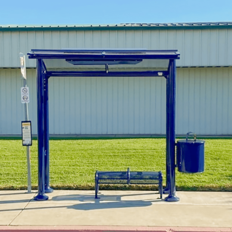 Signa Sunset bus shelter seen head on in blue with a bench and attached trash can to the left side