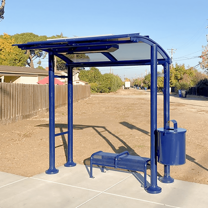 A Signa Sunset bus shelter in blue with a bench and attached trash receptacle