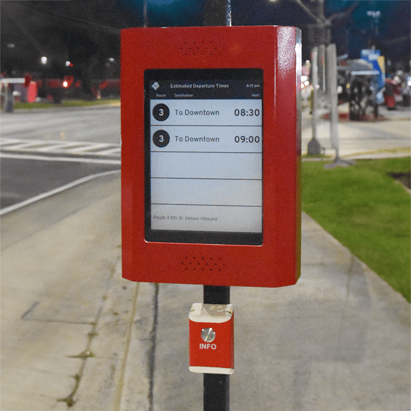 A rider information display is shown attached to a rider stop post with stop timing displayed and an info button below.
