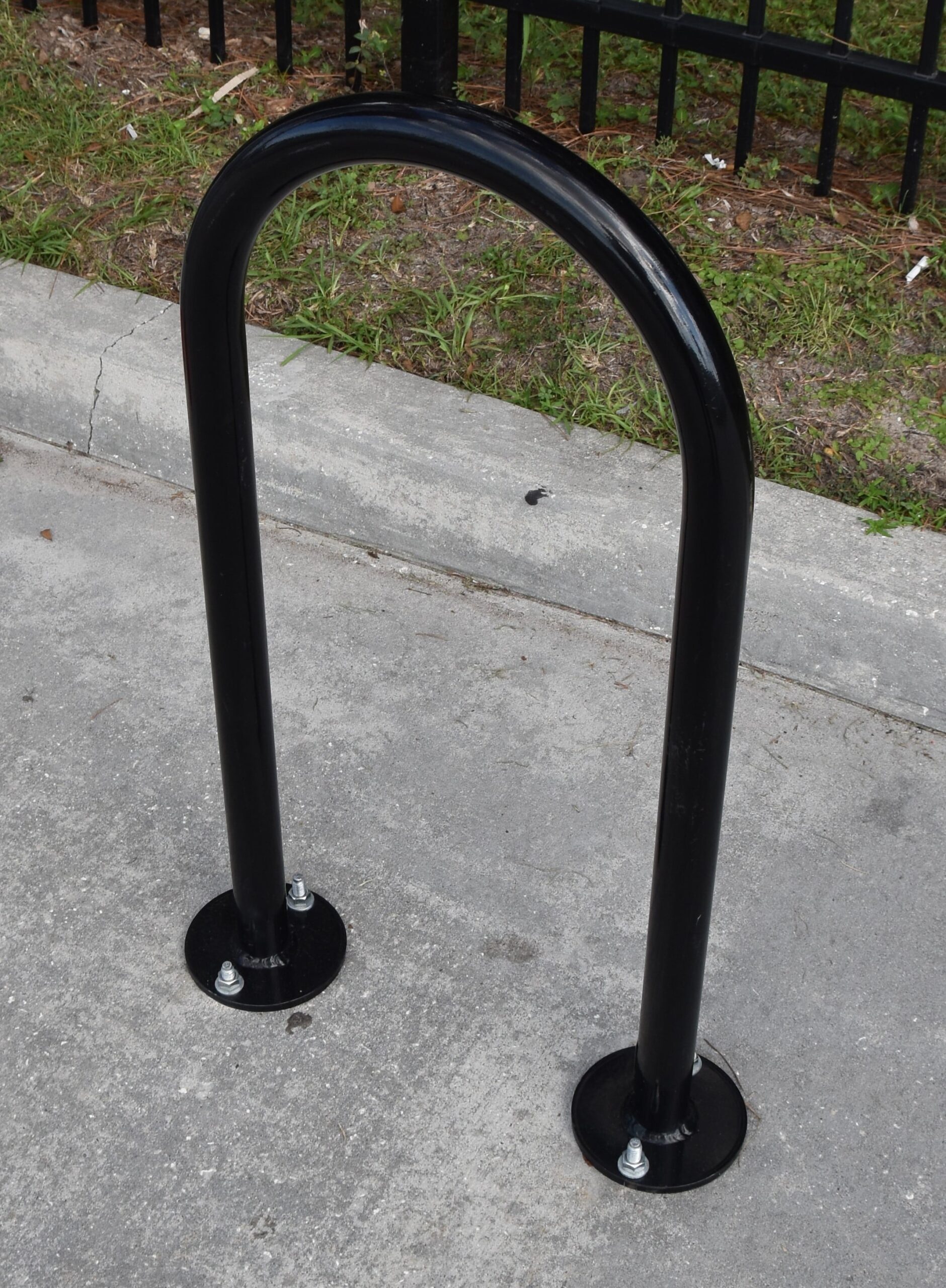 A black arched bike stand is seen from the top right.