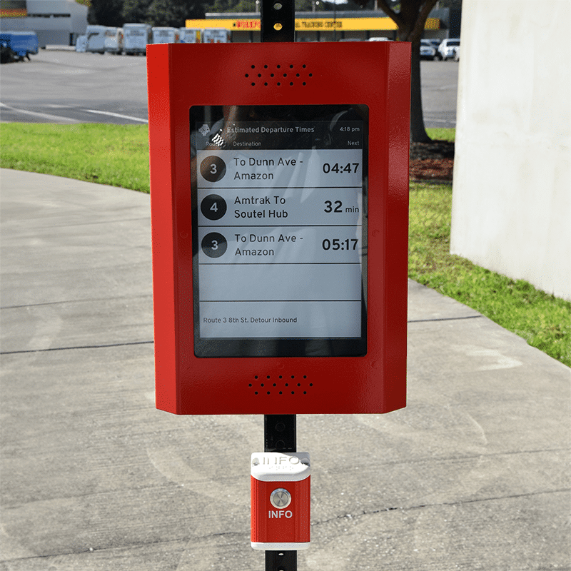 A rider information display is seen from the front view showing timing to the next few stops and an info button below.