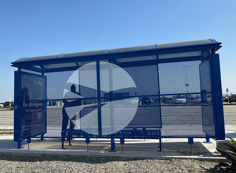 The back of a bus shelter is seen with a custom logo of a plane inside a circle on the back center panel.