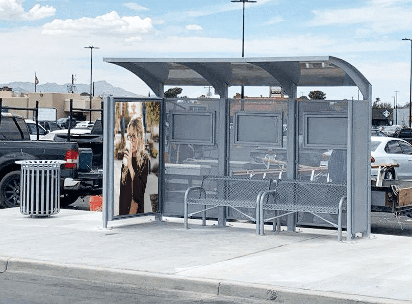 Left facing bus shelter for SunMetro in El Paso, Texas with two benches and large advertising display